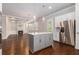 Kitchen island with stainless steel appliances, and an adjacent living room with a fireplace at 3139 Hilltop Drive, Marietta, GA 30066
