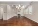 Spacious living room with hardwood floors, a fireplace, built-in shelves and coffered ceiling at 3139 Hilltop Drive, Marietta, GA 30066
