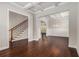 Open living room with hardwood floors, coffered ceilings, staircase, and neutral paint at 3139 Hilltop Drive, Marietta, GA 30066