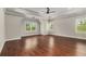 A large, sun-filled bedroom features hardwood floors, a tray ceiling and three windows at 3139 Hilltop Drive, Marietta, GA 30066