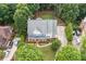A stunning aerial view of a well-maintained two-story home with lush landscaping and a long driveway at 6219 Creekstone Path, Cumming, GA 30041