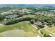 Community aerial shot with a beautiful golf course, pond, clubhouse and verdant surrounding landscape at 6219 Creekstone Path, Cumming, GA 30041