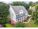 Expansive home with a sprawling lawn surrounded by lush trees at 6219 Creekstone Path, Cumming, GA 30041