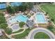 Aerial view of a well-appointed community pool area with multiple pools, a waterslide and tennis courts at 6219 Creekstone Path, Cumming, GA 30041