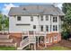 Exterior of house with large deck, a backyard and beautiful landscaping with tiered retaining walls at 6219 Creekstone Path, Cumming, GA 30041