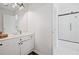 Bright bathroom featuring a white vanity, updated fixtures, a glass door shower, and tile flooring at 6219 Creekstone Path, Cumming, GA 30041