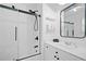 Modern bathroom features a tub and shower, with a sleek sink and a decorative mirror at 6219 Creekstone Path, Cumming, GA 30041