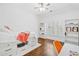Bright bedroom with hardwood floors, a built-in bed, and natural light, offering a versatile and stylish space at 6219 Creekstone Path, Cumming, GA 30041
