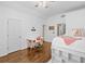 Bright bedroom with hardwood floors, a built-in bed, and a desk area, offering a versatile and stylish space at 6219 Creekstone Path, Cumming, GA 30041