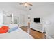 Comfortable bedroom featuring hardwood floors, ensuite bathroom, and a TV, offering a stylish and relaxing space at 6219 Creekstone Path, Cumming, GA 30041