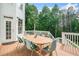 Outdoor deck area featuring a dining table and chairs, perfect for backyard relaxation and entertaining at 6219 Creekstone Path, Cumming, GA 30041