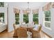 Cozy dining area featuring a round table with wicker chairs and lots of natural light at 6219 Creekstone Path, Cumming, GA 30041