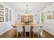 Elegant dining room with large table, chandelier and butterfly artwork at 6219 Creekstone Path, Cumming, GA 30041