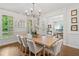 Bright dining area with large table, chandelier and hardwood floors at 6219 Creekstone Path, Cumming, GA 30041