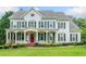 Elegant two-story white home with black shutters, inviting front porch, and well-manicured lawn at 6219 Creekstone Path, Cumming, GA 30041