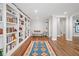 Charming library featuring floor-to-ceiling bookshelves and rich hardwood floors, and a sitting area at 6219 Creekstone Path, Cumming, GA 30041