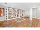 Beautiful library room with floor-to-ceiling bookshelves, comfortable seating, and warm wood floors at 6219 Creekstone Path, Cumming, GA 30041