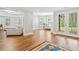 Bright, open-plan living room with hardwood floors and access to a backyard through glass doors at 6219 Creekstone Path, Cumming, GA 30041