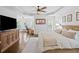Spacious bedroom features hard wood floors, with ceiling fan and comfortable bed and a view to an office space at 6219 Creekstone Path, Cumming, GA 30041