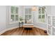 Cozy sitting area with large windows, plantation shutters, and hardwood floors for a light-filled space at 6219 Creekstone Path, Cumming, GA 30041