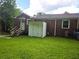 View of the backyard with a small storage shed and stairs to the back door of the house at 1753 Cahoon Sw St, Atlanta, GA 30310