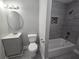 Updated bathroom with modern tiles, new vanity, and shower-tub combo at 1753 Cahoon Sw St, Atlanta, GA 30310