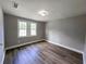A cozy bedroom with two windows for natural light and wood-look laminate flooring at 1753 Cahoon Sw St, Atlanta, GA 30310