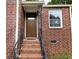 Inviting brick entryway with stairs and a classic front door at 1753 Cahoon Sw St, Atlanta, GA 30310