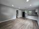 Spacious living room adjacent to the kitchen, featuring new flooring and paint at 1753 Cahoon Sw St, Atlanta, GA 30310
