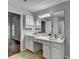 Bathroom vanity with white cabinets and tiled floors. Includes a makeup counter space at 1965 Sterling Creek Ct, Snellville, GA 30078