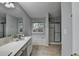 This bathroom offers a large mirror, soaking tub, stand up shower and tile floors at 1965 Sterling Creek Ct, Snellville, GA 30078