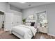 This staged bedroom features hardwood floors, neutral paint, and natural lighting at 1965 Sterling Creek Ct, Snellville, GA 30078