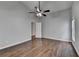 A bedroom featuring hardwood floors, a ceiling fan, and a neutral color palette at 1965 Sterling Creek Ct, Snellville, GA 30078