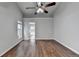 Bright bedroom featuring hardwood floors, a ceiling fan, and neutral paint at 1965 Sterling Creek Ct, Snellville, GA 30078