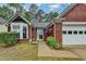 Charming one story brick home with manicured lawn and attached two car garage at 1965 Sterling Creek Ct, Snellville, GA 30078