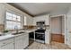 A kitchen featuring white cabinets, stainless steel appliances, and tile flooring at 1965 Sterling Creek Ct, Snellville, GA 30078