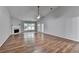Spacious living room featuring hardwood floors, a fireplace, and a ceiling fan at 1965 Sterling Creek Ct, Snellville, GA 30078