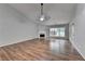 A large living room with hardwood floors, a fireplace, and ample natural light at 1965 Sterling Creek Ct, Snellville, GA 30078