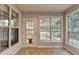 Sunroom with tile floors, multiple windows, and a door leading to the backyard at 1965 Sterling Creek Ct, Snellville, GA 30078