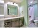 Well-lit bathroom featuring modern vanity, a spacious mirror, and a shower-tub combination with subway tile at 2210 Cumberland Se Ct, Smyrna, GA 30080