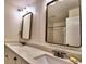 Elegant bathroom with double vanity, granite countertops, decorative mirrors, and a shower-tub combination at 2210 Cumberland Se Ct, Smyrna, GA 30080