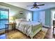 Charming bedroom featuring a queen-sized bed, hardwood floors, a sunny window, and a private balcony access at 2210 Cumberland Se Ct, Smyrna, GA 30080