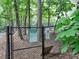 Fenced dog park with rules sign posted, offering a secure area for small dogs to exercise in a wooded environment at 2210 Cumberland Se Ct, Smyrna, GA 30080