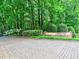 Stone entrance to Vinings Run with lush greenery and trees, set on a charming cobblestone street at 2210 Cumberland Se Ct, Smyrna, GA 30080