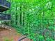 Exterior view of the home with back porch nestled among the trees at 2210 Cumberland Se Ct, Smyrna, GA 30080