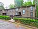 A well-maintained condo complex showcasing lush greenery and multiple windows for ample natural light at 2210 Cumberland Se Ct, Smyrna, GA 30080