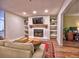 Comfortable living room with a fireplace, built-in shelving, and hardwood floors at 2210 Cumberland Se Ct, Smyrna, GA 30080