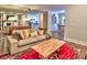 Bright and airy living room featuring hardwood floors, a plush sofa, stylish decor, and an open layout to the kitchen at 2210 Cumberland Se Ct, Smyrna, GA 30080