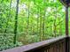 Enjoy peaceful nature views from this home's cozy porch and wooded surroundings at 2210 Cumberland Se Ct, Smyrna, GA 30080