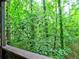 Enjoy peaceful nature views from this home's cozy porch and wooded surroundings at 2210 Cumberland Se Ct, Smyrna, GA 30080